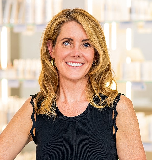 Woman smiling in a beauty product store.