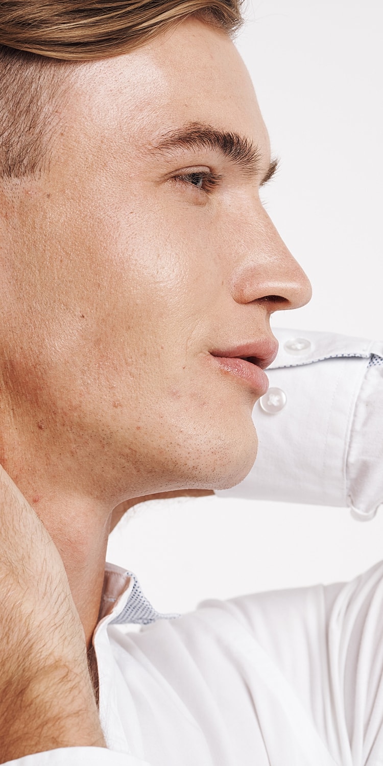 Woman with styled hair and natural makeup.